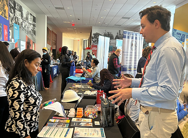 People talking with potential employers at a career fair