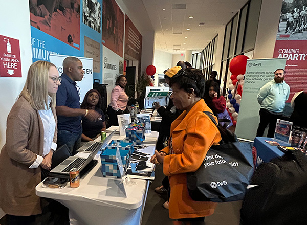 People talking with potential employers at a career fair
