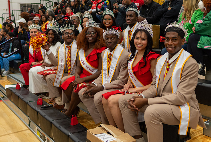 Royal court sitting in bleachers