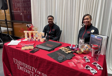 A man and a woman sitting at a recruitment 