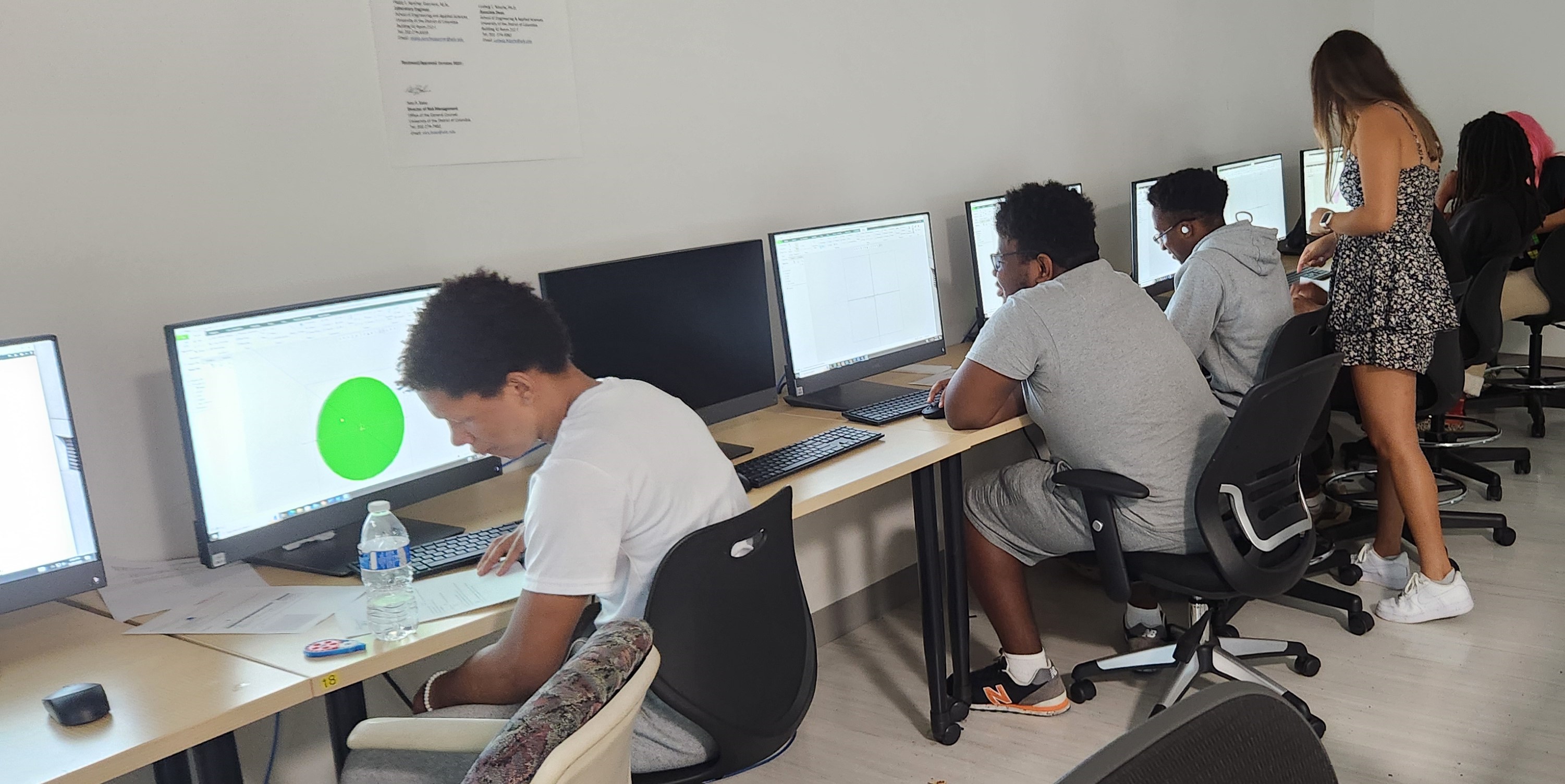 Summer students work on coding.