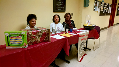 officers Ebony Framer-Mangum (President), Andrea Jenkins (VP), and Jamila Stone (Treasurer/Historian) of Sigma Tau Delta - Alpha Epsilon Rho (the UDC chapter of the International English Honor Society), promoting our organization and running our "Words with Children" gift drive for literary presents for homeless children, as well as our ongoing "Better World Book Drive" collecting textbooks for distribution to third world countries.