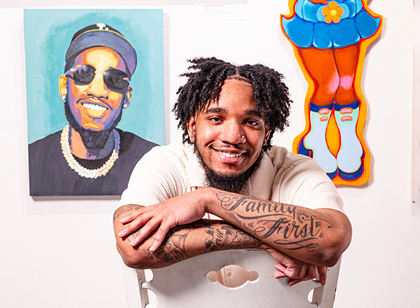 UDC art student sitting backwards on a chair