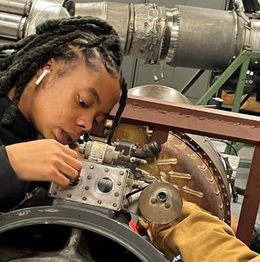 Aviation student working on a machine.