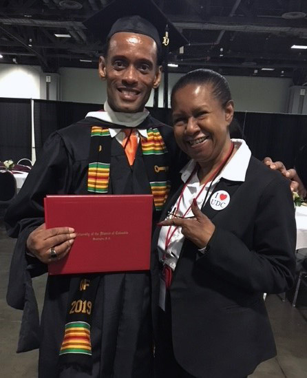 Denise Slaughter standing next to her brother at UDC Commencement