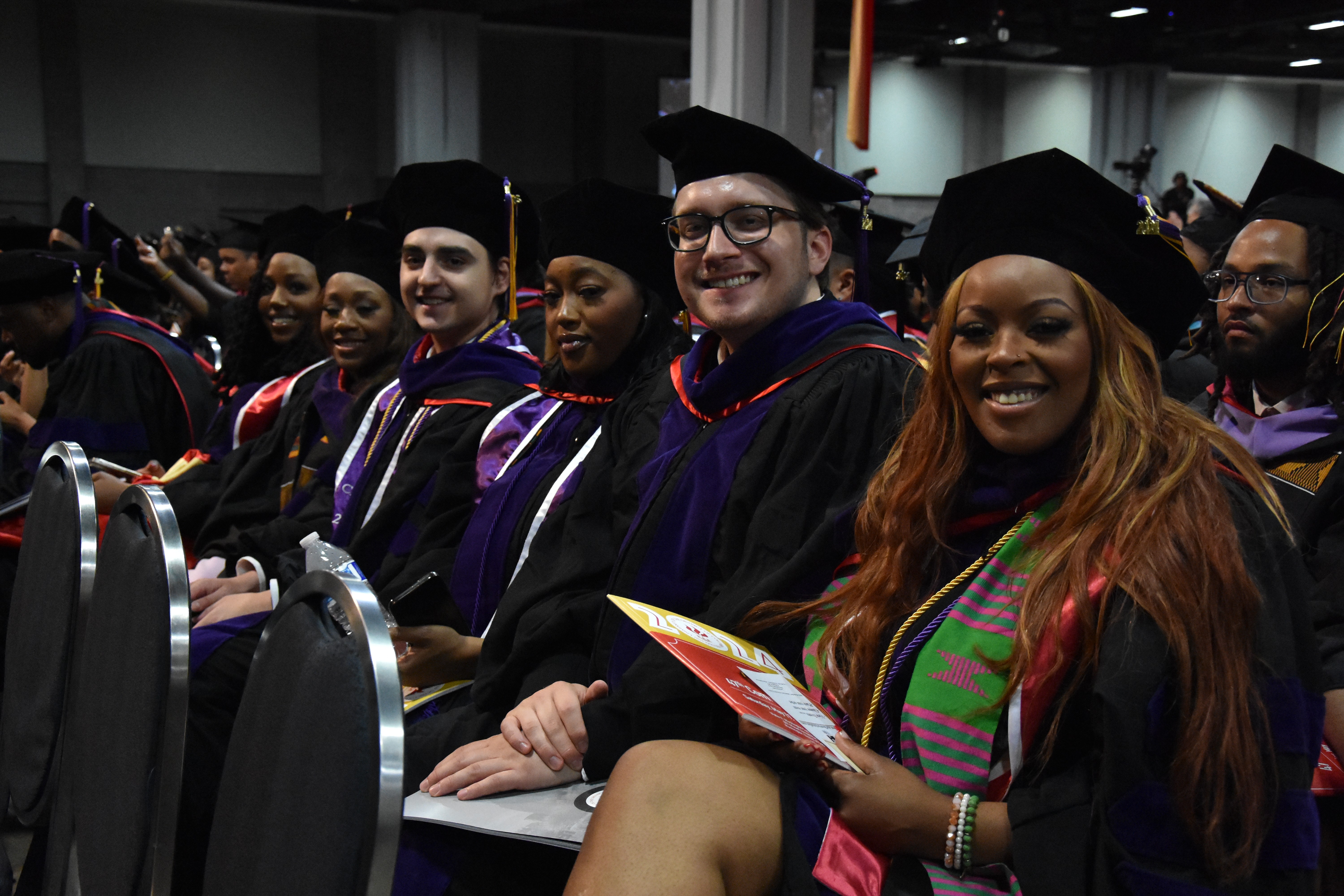 Students in graduation attire waiting for commencement.
