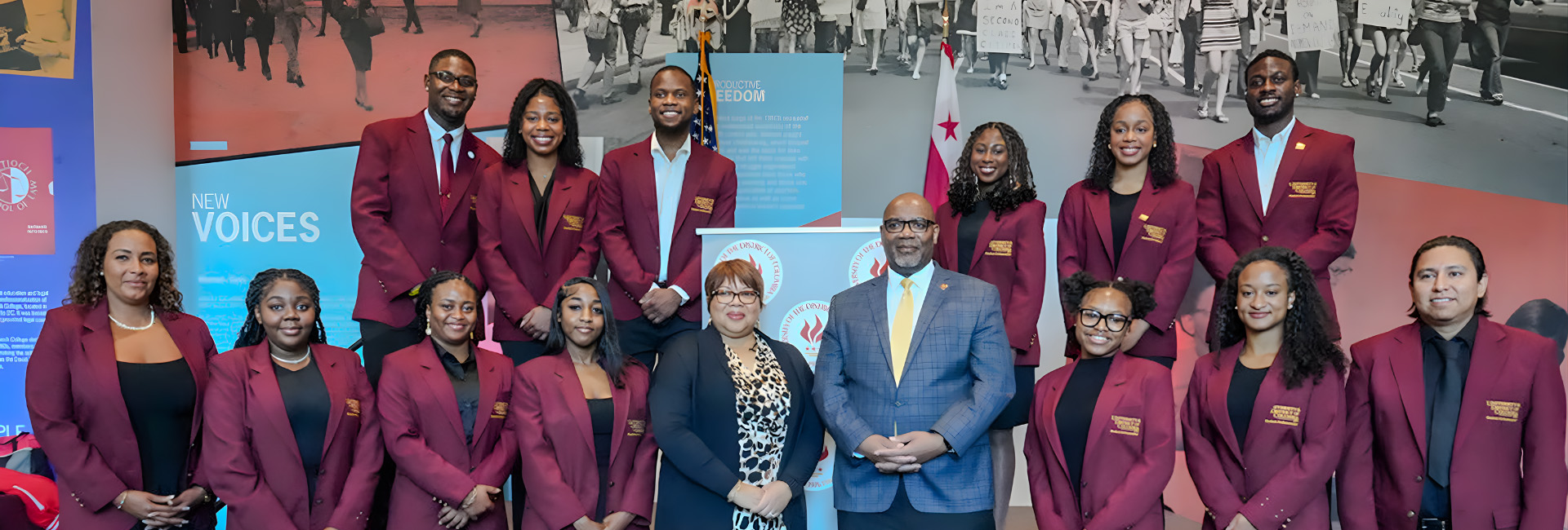 UDC Student Ambassadors wearing burgundy jackets stand with President and Mrs. Edington.
