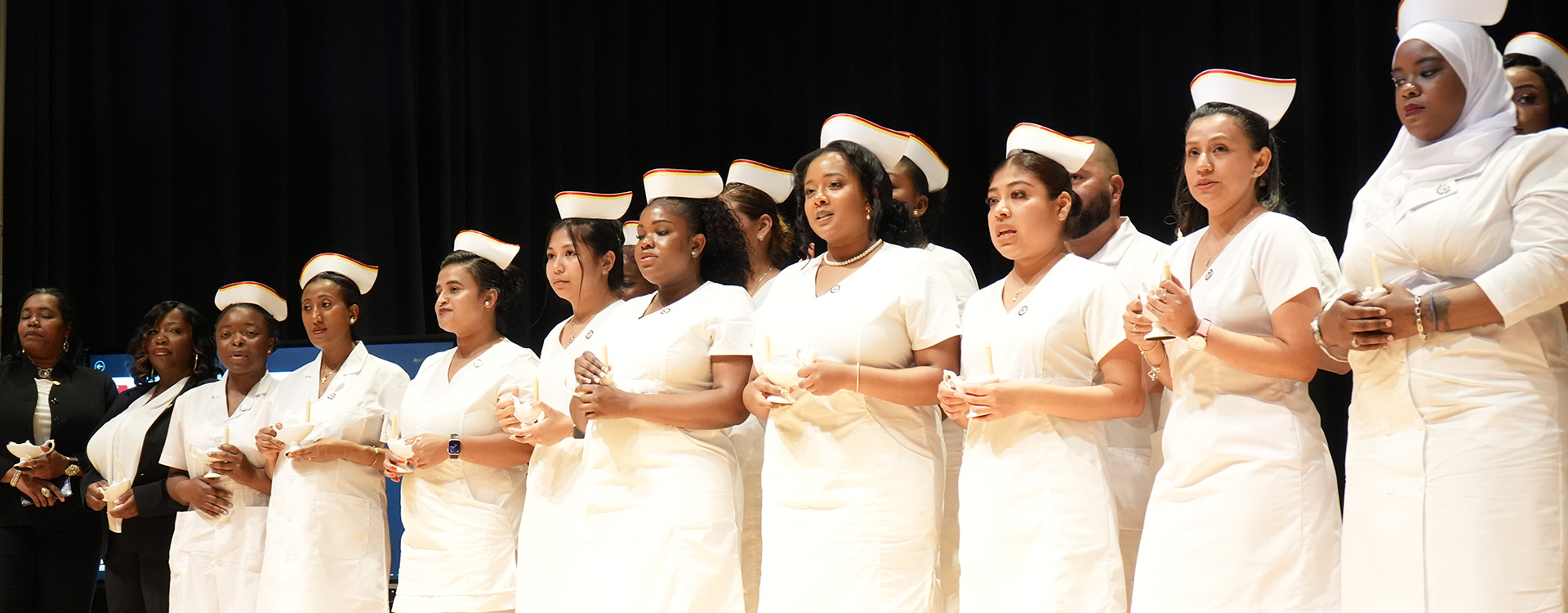 Nursing students standing in a line at a pinning ceremony