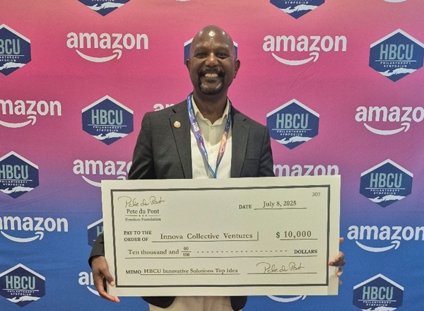 Rodney Trapp, VP for Advancement holding a $10,000 check for UDC Foundation