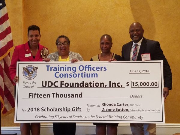 UDC receiving a donation from Training Officers Consortium