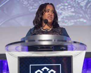 Scholar speaking at podium