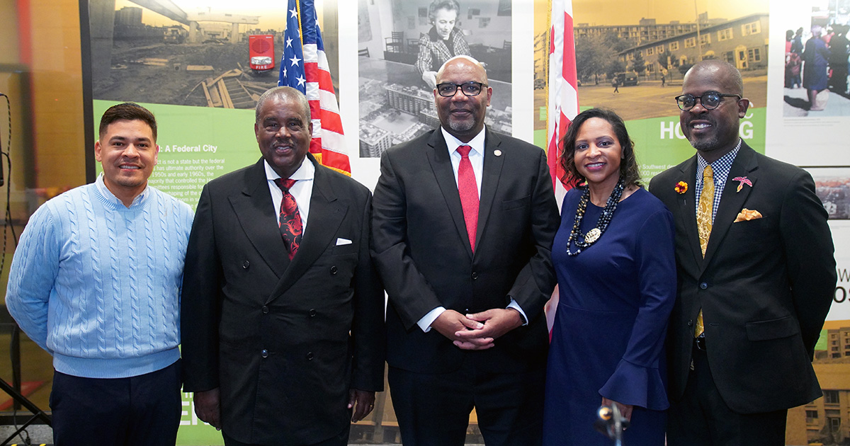 Five members of the Board of Trustees standing together and smiling