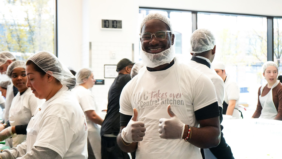 UDC student smiling and giving two thumbs up 