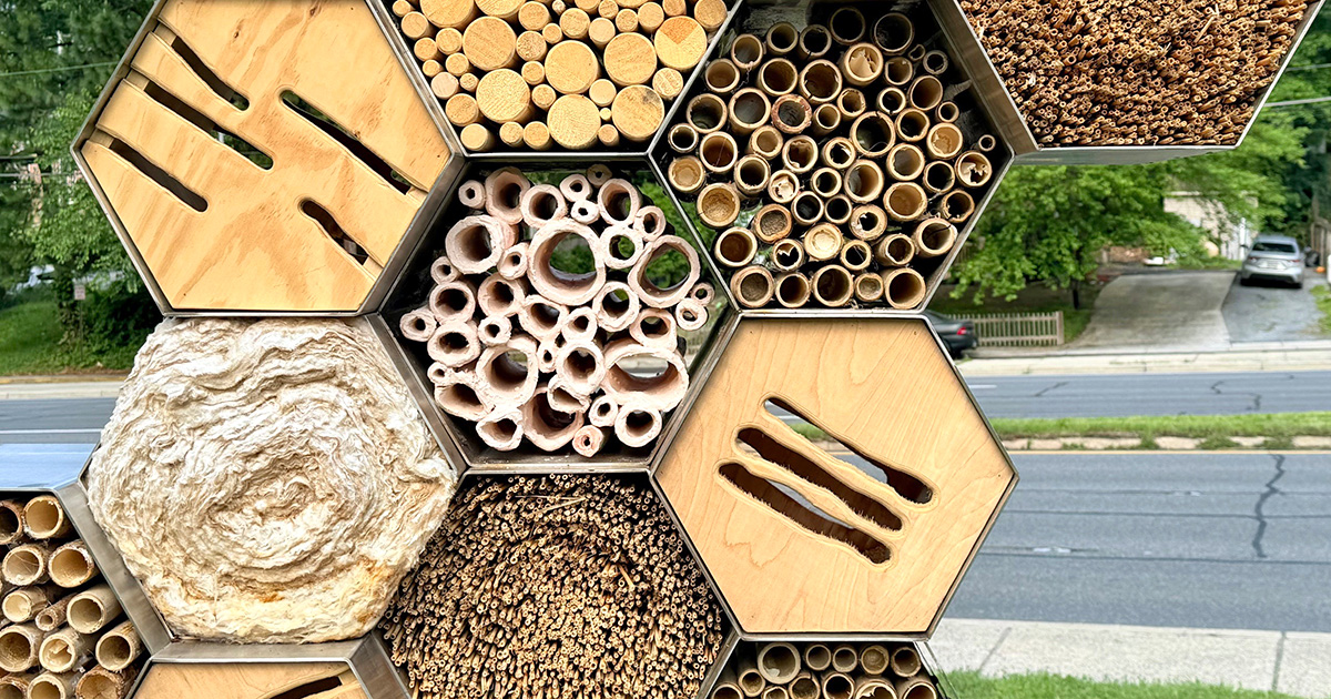 Detail of a sculpture comprising several hexagons in metal and wood.