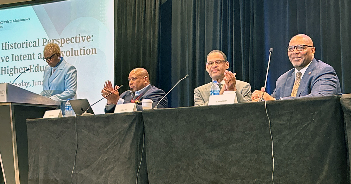 Title III conference speakers at a table