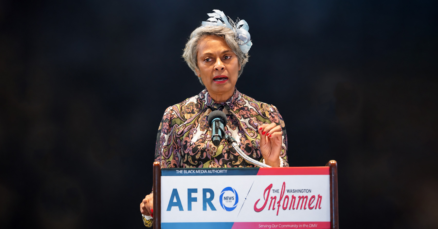 April Massey speaking at a podium.