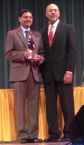 Image of Dr. Behera receiving award from President Mason.