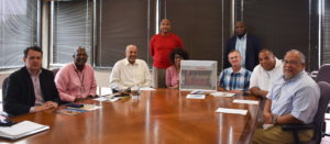 Master sculptor Brian Hanlon (third from right), Board of Trustee member Barrington Scott (second from right) and E.B. Henderson III (far right) meeting with UDC leadership to discuss the new statue.