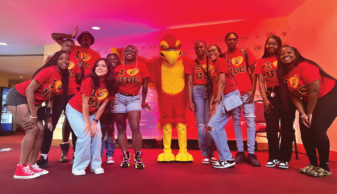 Student volunteers pose with Felix the Firebird at the New Student Orientation
